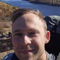 Colin MacRae hiking above a lake in fall